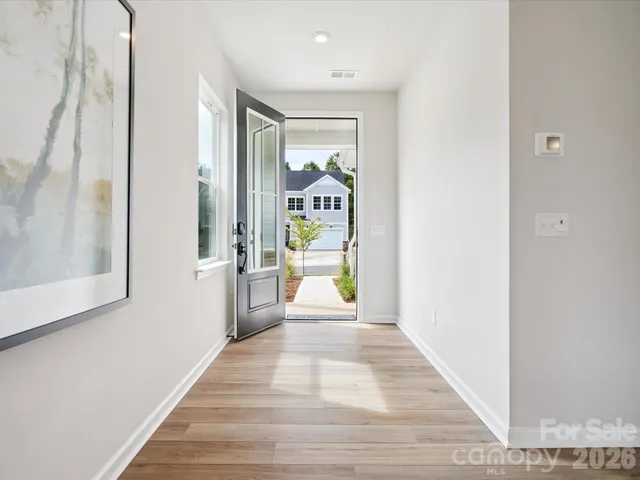 a view of a hallway view with wooden floor and staircase