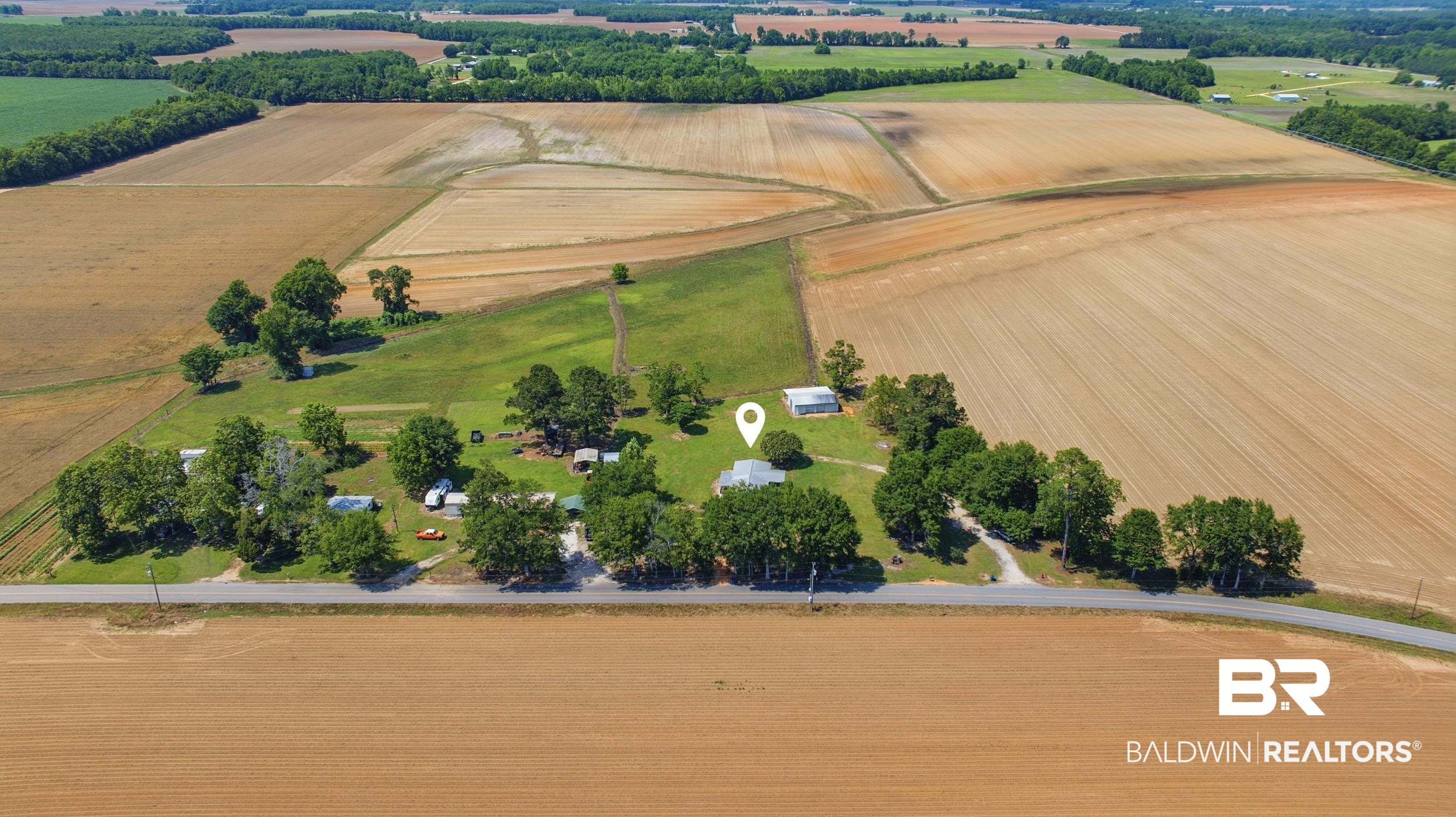 926 Tumbling Lane Atmore, AL 36502 - Photo 51 of 56 Expansive agricultural property featuring multiple cultivated fields and forested areas