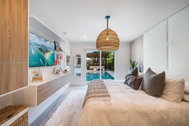 a bedroom with a bed and a view of living room