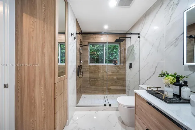 a bathroom with a toilet a sink and shower