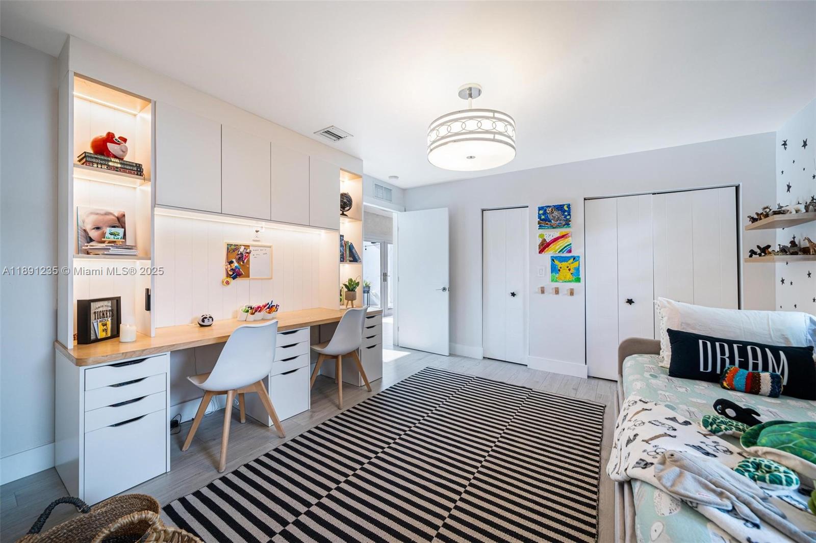 2437 Southwest 25th Terrace Miami, FL 33133 - Photo 18 of 32 a living room with furniture and a baby crib