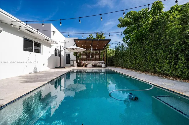 a view of a backyard with sitting area