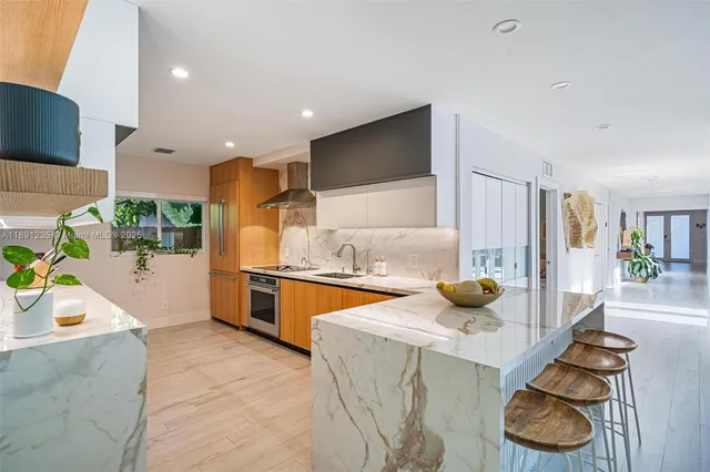 a kitchen with stainless steel appliances granite countertop a sink and a stove