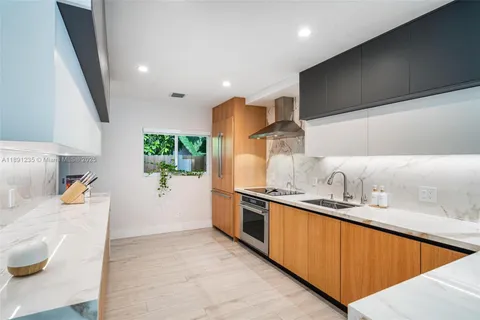 a kitchen with stainless steel appliances granite countertop a sink stove and cabinets