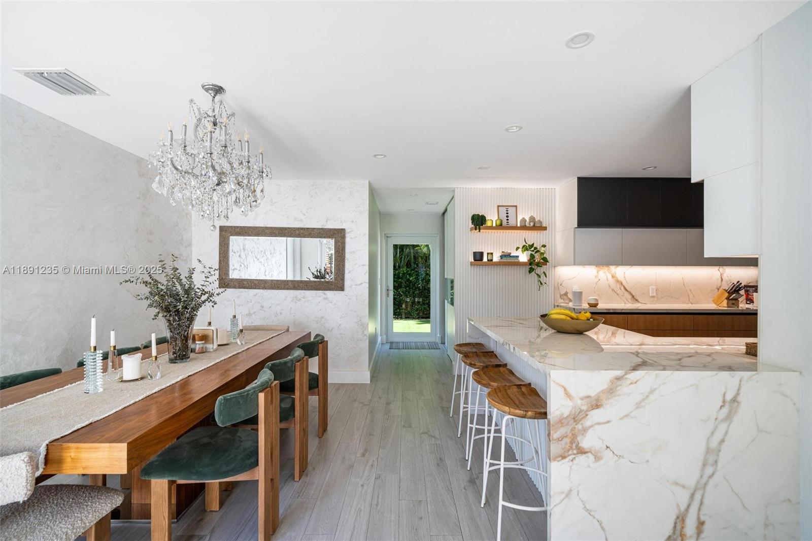 2437 Southwest 25th Terrace Miami, FL 33133 - Photo 10 of 32 a living room with furniture and a chandelier