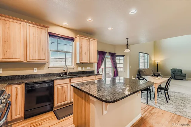a kitchen with stainless steel appliances granite countertop stove top oven and cabinets