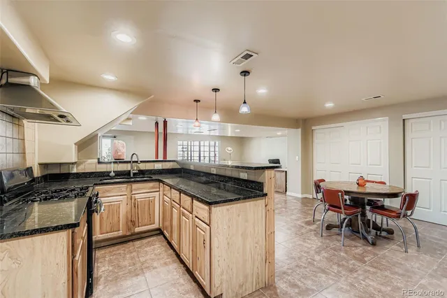 a kitchen with stainless steel appliances granite countertop a sink and cabinets