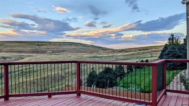 a view of a balcony with wooden floor and city view