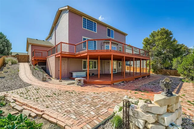 a front view of a house with a yard covered with snow