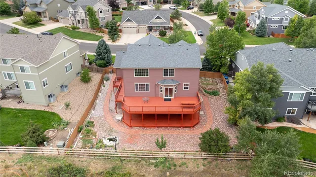 an aerial view of a house with a swimming pool