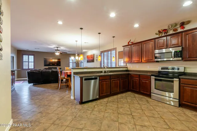 a kitchen with stainless steel appliances granite countertop a stove and a sink