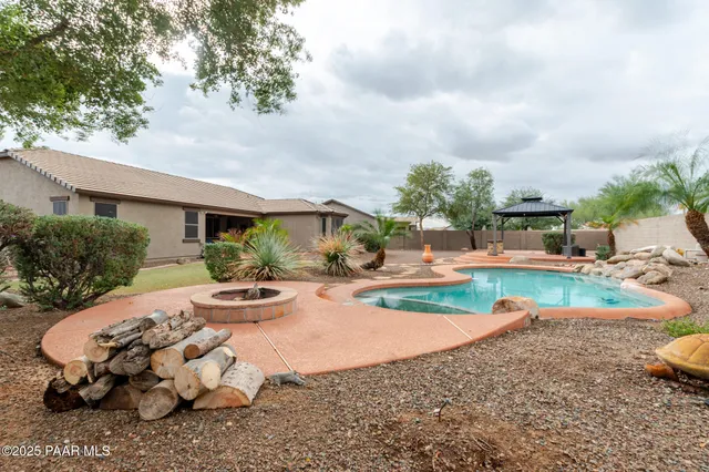 a view of a house with backyard and sitting area