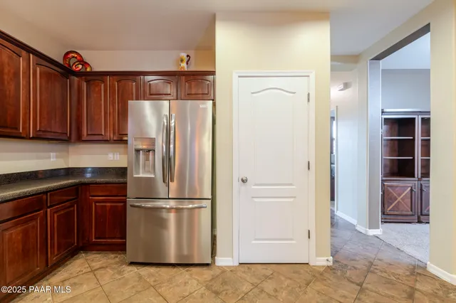 a kitchen with a refrigerator and a sink