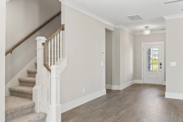 a view of entryway with wooden floor and stair