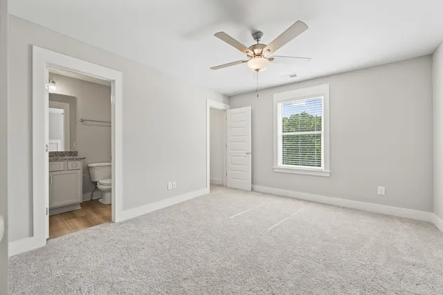 wooden floor in an empty room and a bathroom