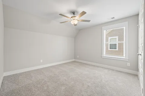 a view of a livingroom with a ceiling fan and window