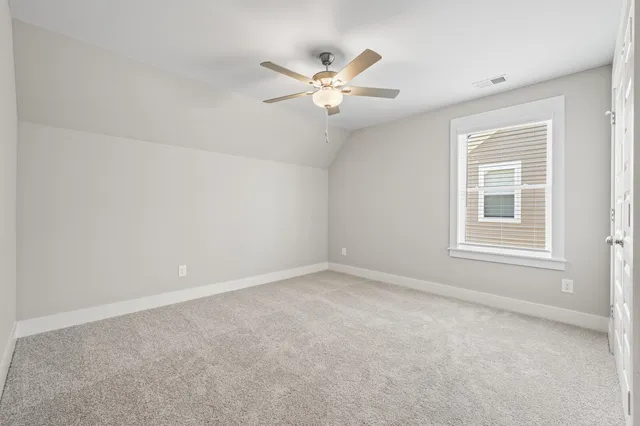 a view of a livingroom with a ceiling fan and window