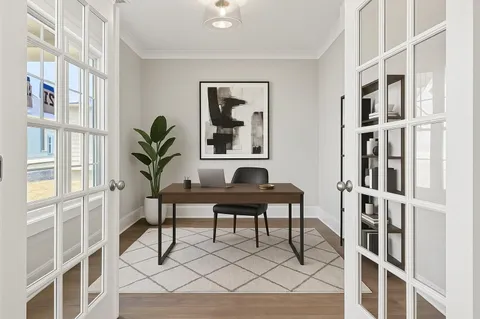 a view of a workspace with furniture and a potted plant