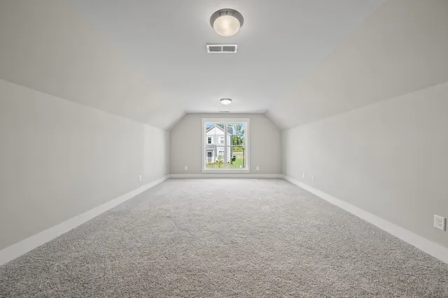 an empty room with windows and painted walls