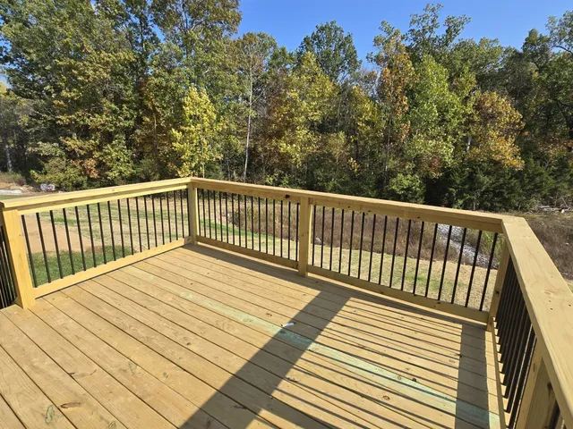 a balcony with wooden floor and fence