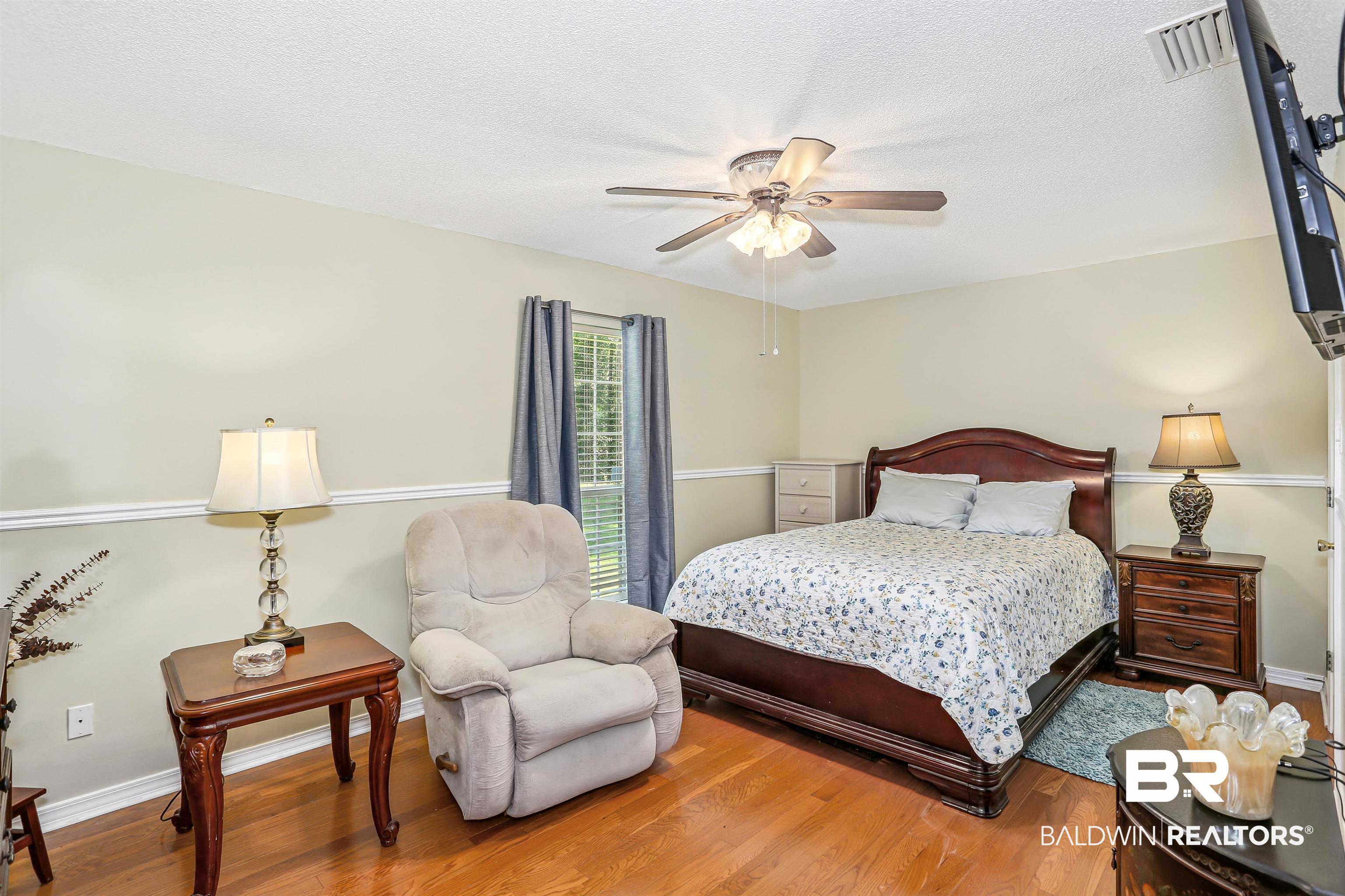 32334 Riverlake Road Seminole, AL 36574 - Photo 29 of 47 Bedroom featuring wood finished floors, a ceiling fan, and a textured ceiling