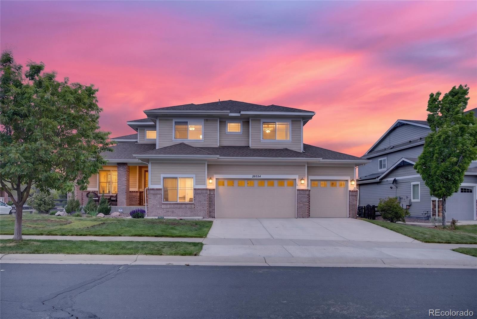 20554 East Shady Ridge Road Parker, CO 80134 - Photo 48 of 49 a front view of a house with a yard