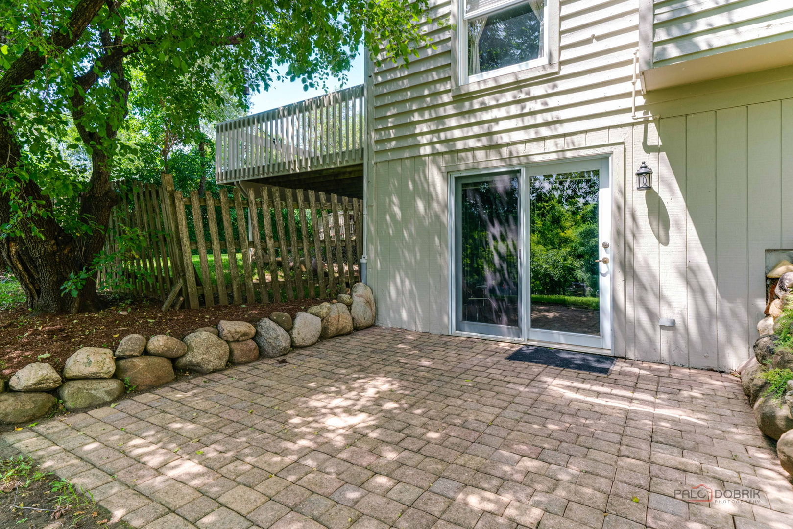 24 Hickory Road Oakwood Hills, IL 60013 - Photo 29 of 35 a view of a wooden house with a large window and potted plants