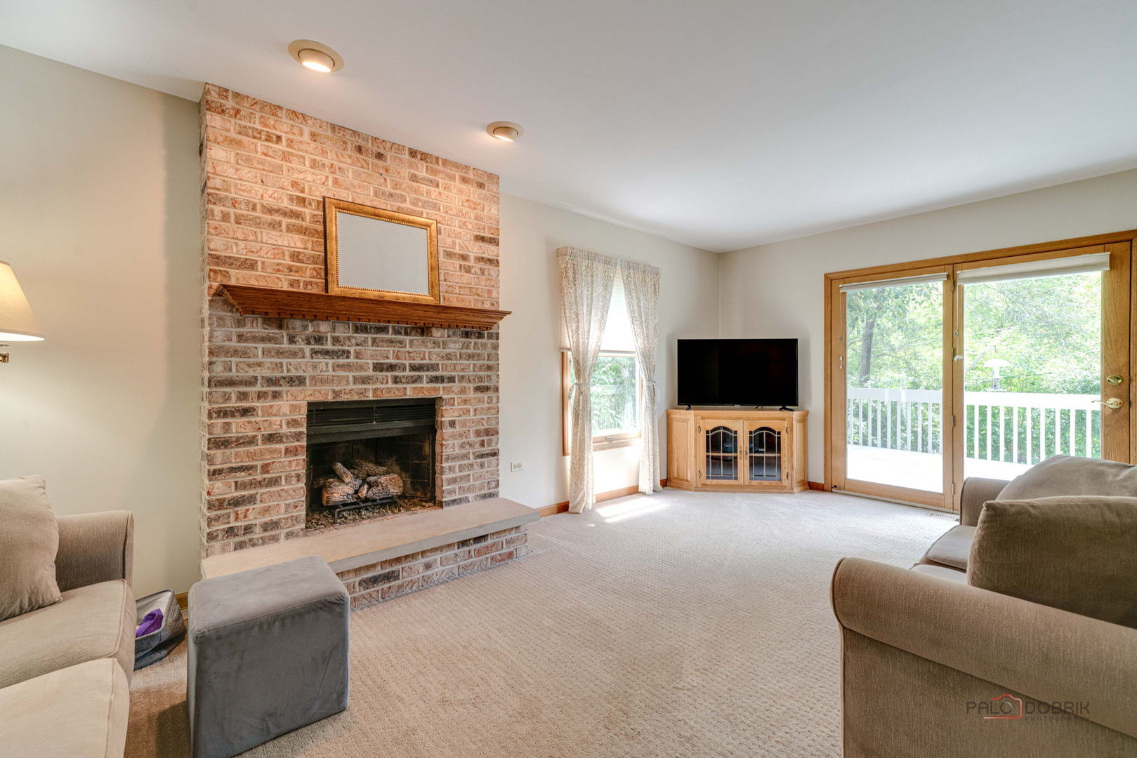 24 Hickory Road Oakwood Hills, IL 60013 - Photo 9 of 35 a living room with furniture a flat screen tv and a fireplace