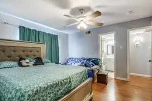 a bedroom with bed and wooden floor