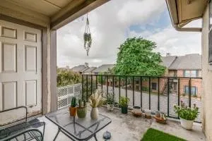 a view of a balcony with furniture and floor to ceiling window