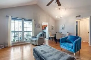 a living room with furniture a ceiling fan and a window