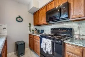 a kitchen with stainless steel appliances granite countertop a stove and a microwave