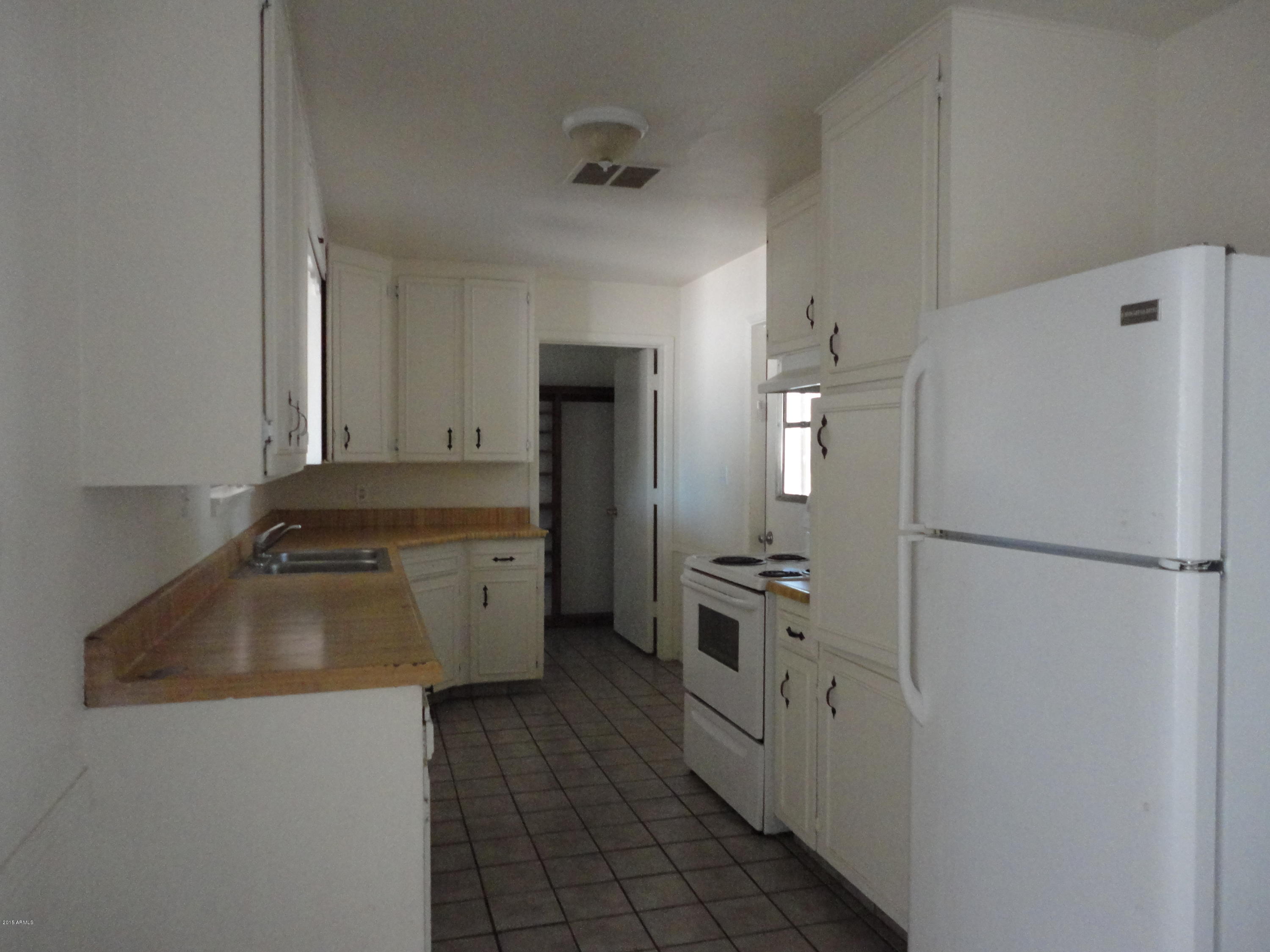 1202 West Elna Rae Street Tempe, AZ 85281 - Photo 3 of 7 a kitchen with a refrigerator sink and stove