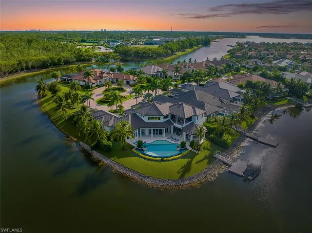 an aerial view of residential houses with outdoor space and river