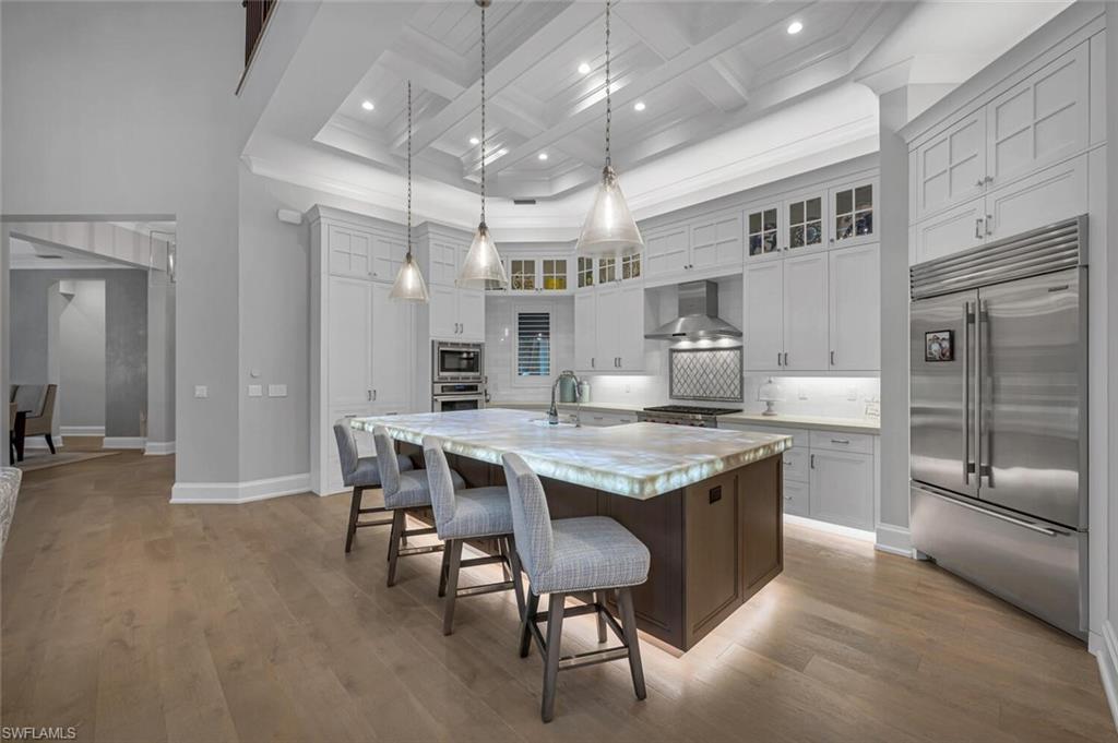 11910 Via Salerno Way Miromar Lakes, FL 33913 - Photo 11 of 50 a kitchen with granite countertop center island and stainless steel appliances