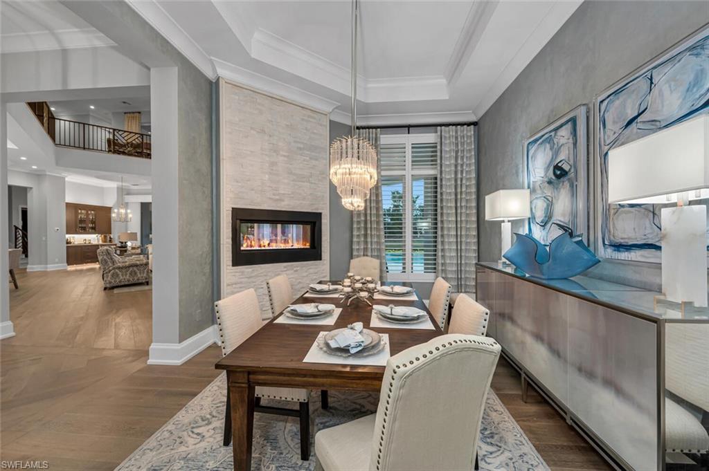 11910 Via Salerno Way Miromar Lakes, FL 33913 - Photo 14 of 50 a view of a dining room with furniture window and wooden floor