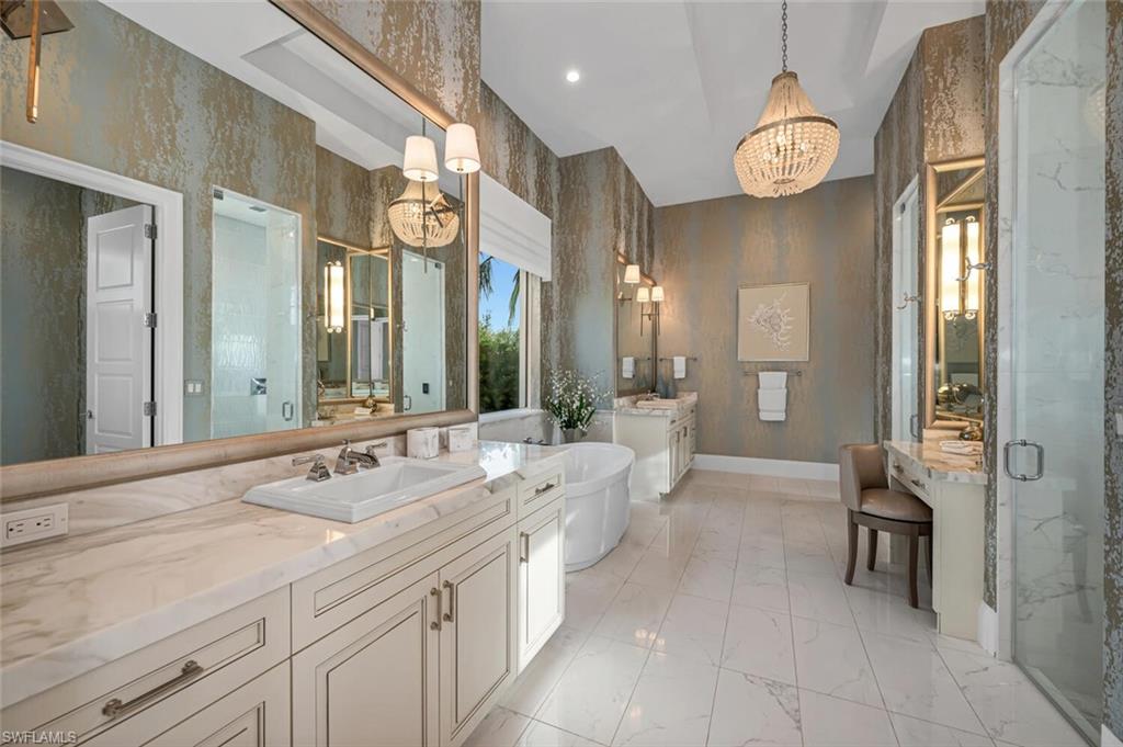 11910 Via Salerno Way Miromar Lakes, FL 33913 - Photo 16 of 50 a spacious bathroom with a double vanity sink and a mirror