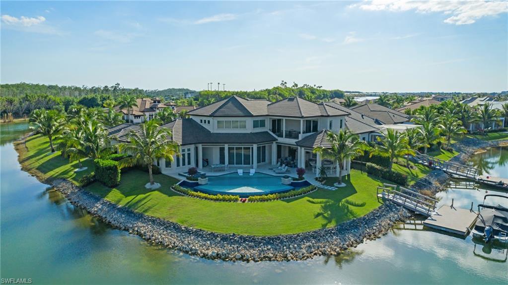 11910 Via Salerno Way Miromar Lakes, FL 33913 - Photo 2 of 50 an aerial view of a house with a garden and lake view