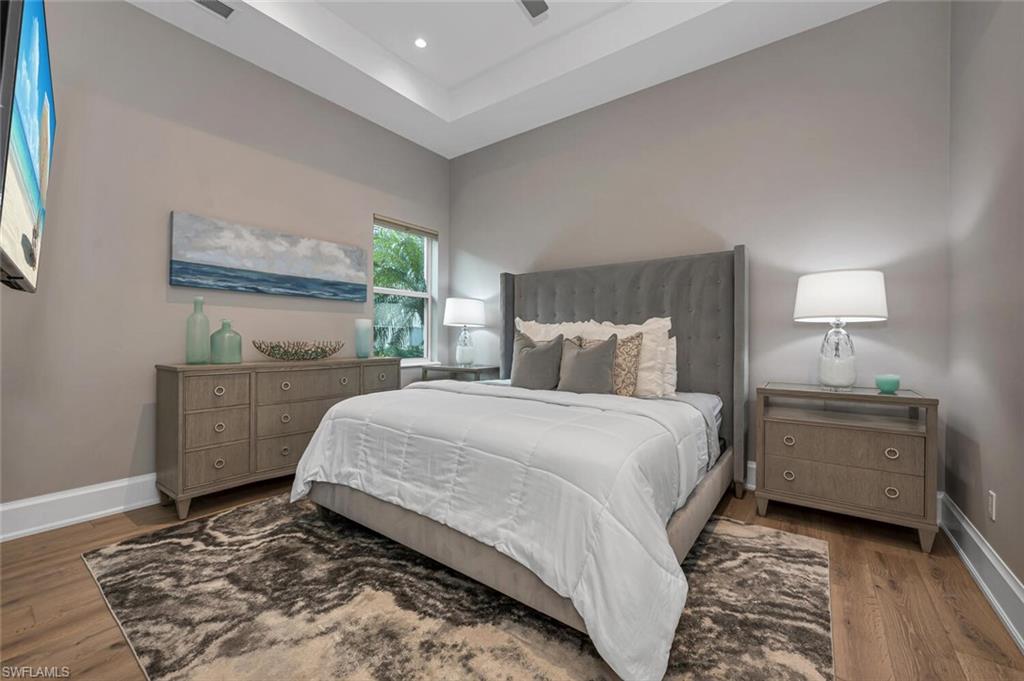 11910 Via Salerno Way Miromar Lakes, FL 33913 - Photo 23 of 50 a bedroom with a bed and a lamp on dresser