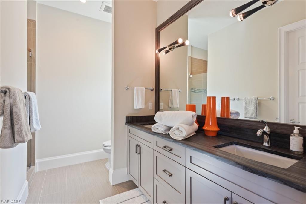 11910 Via Salerno Way Miromar Lakes, FL 33913 - Photo 30 of 50 a bathroom with a granite countertop sink and a mirror