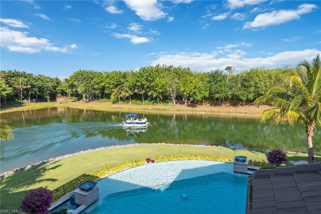 11910 Via Salerno Way Miromar Lakes, FL 33913 - Photo 31 of 50 a view of a lake with a yard