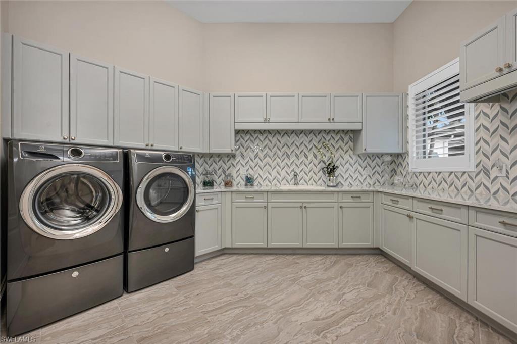 11910 Via Salerno Way Miromar Lakes, FL 33913 - Photo 34 of 50 a kitchen with a sink a stove and cabinets