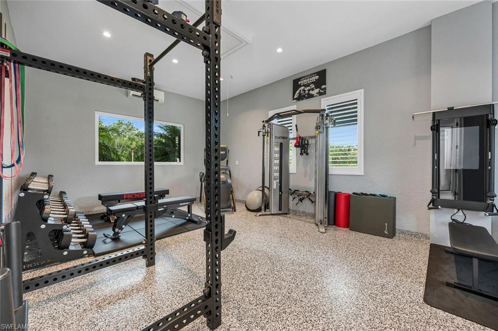 11910 Via Salerno Way Miromar Lakes, FL 33913 - Photo 35 of 50 a living room with furniture and a flat screen tv