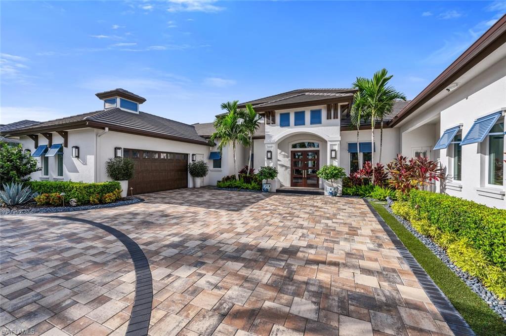 11910 Via Salerno Way Miromar Lakes, FL 33913 - Photo 38 of 50 a front view of a house with garden