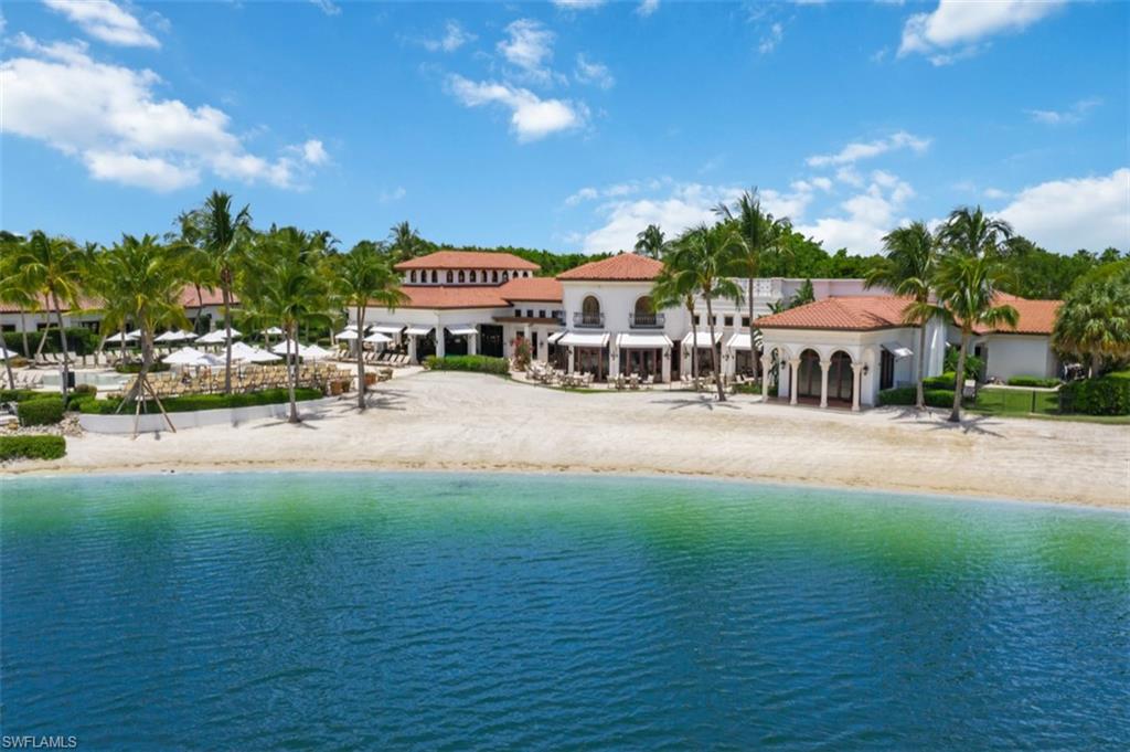 11910 Via Salerno Way Miromar Lakes, FL 33913 - Photo 50 of 50 a front view of a building with a garden and trees