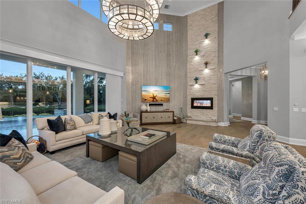 11910 Via Salerno Way Miromar Lakes, FL 33913 - Photo 7 of 50 a living room with furniture chandelier and a large window