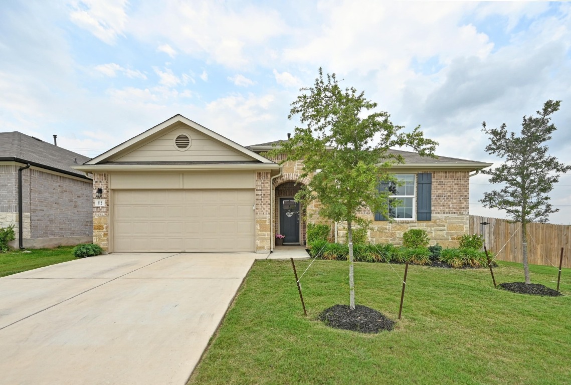 112 Bulbine Cove Kyle, TX 78640 - Photo 1 of 1 a front view of a house with a garden and plants