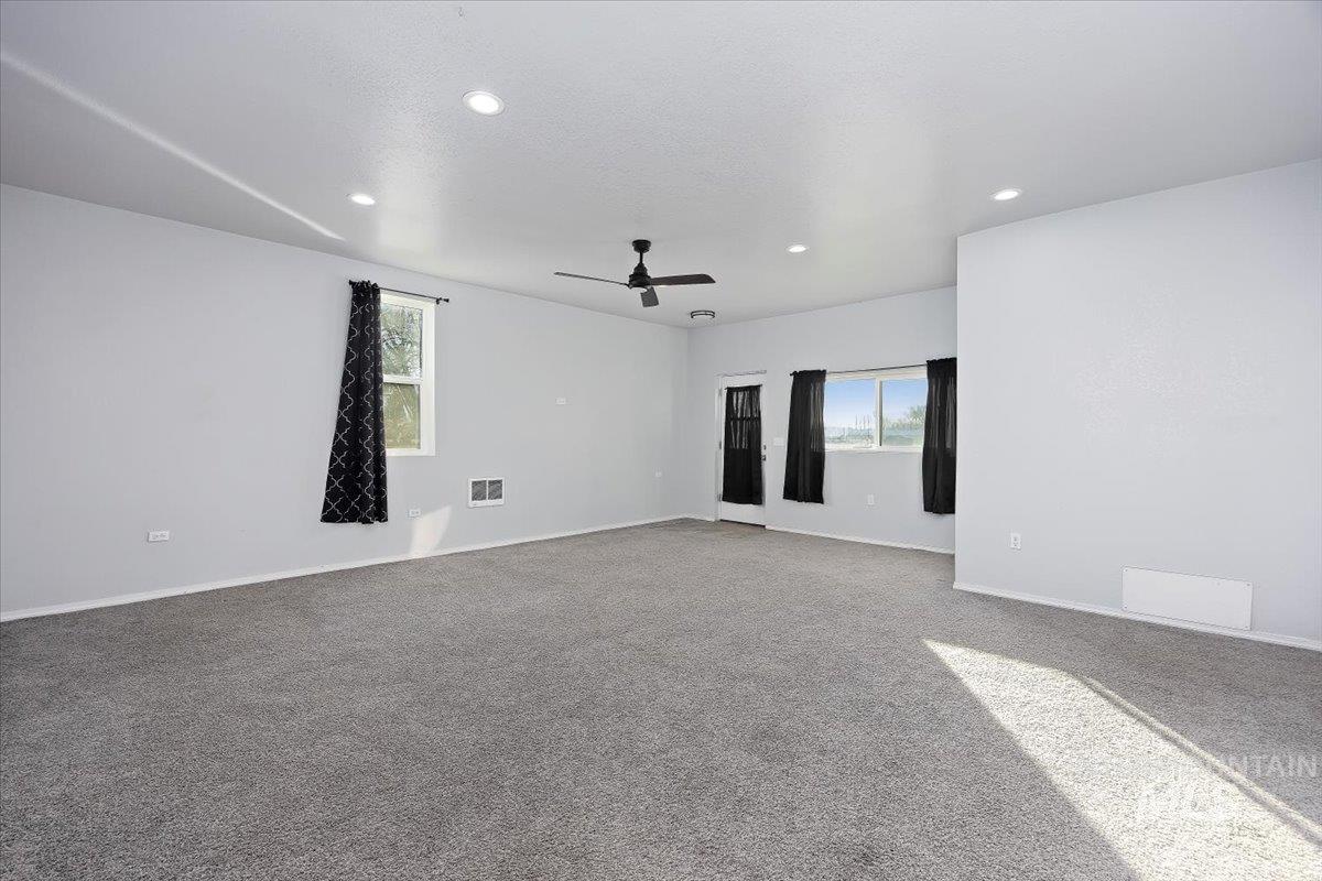 810 South 9th Street Rupert, ID 83350 - Photo 14 of 31 Unfurnished room with carpet flooring, recessed lighting, healthy amount of natural light, a ceiling fan, and a textured ceiling
