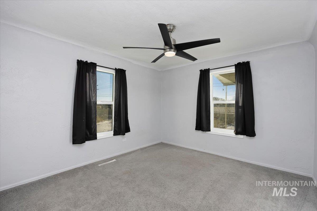 810 South 9th Street Rupert, ID 83350 - Photo 21 of 31 Carpeted spare room featuring plenty of natural light and ceiling fan