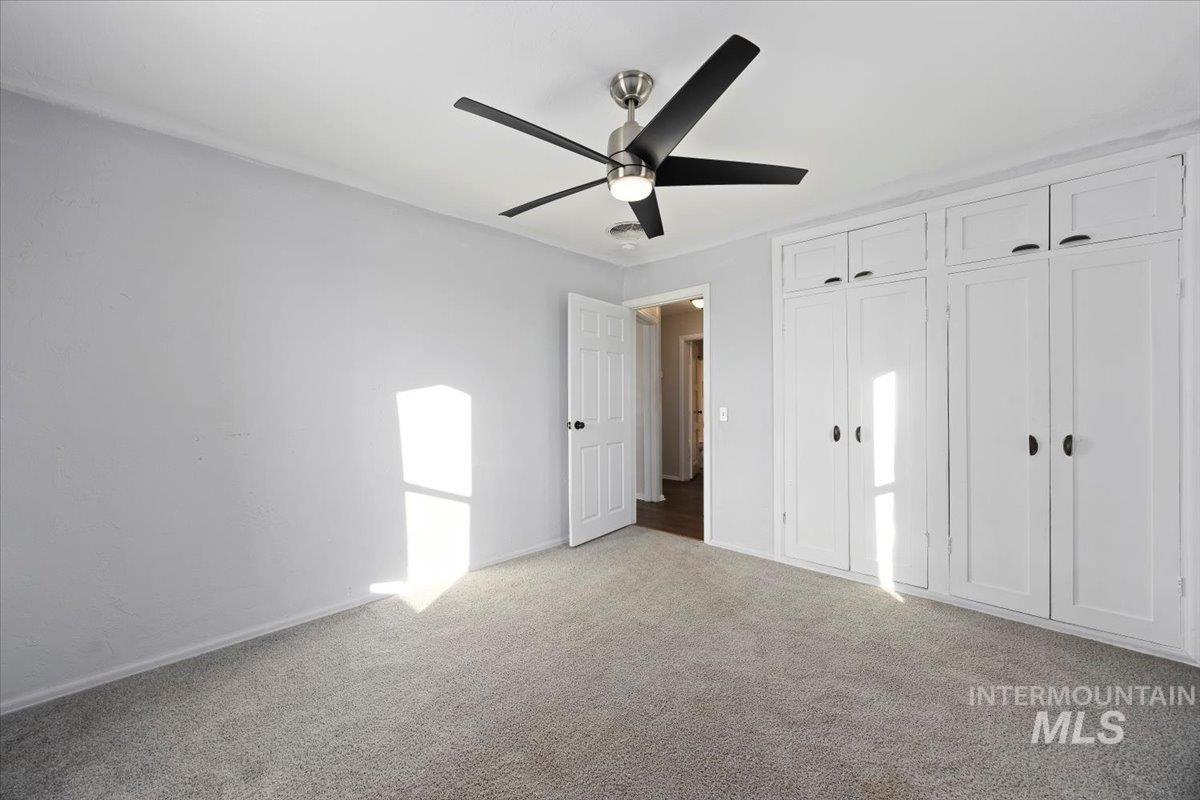 810 South 9th Street Rupert, ID 83350 - Photo 22 of 31 Unfurnished bedroom featuring carpet flooring, a closet, and ceiling fan